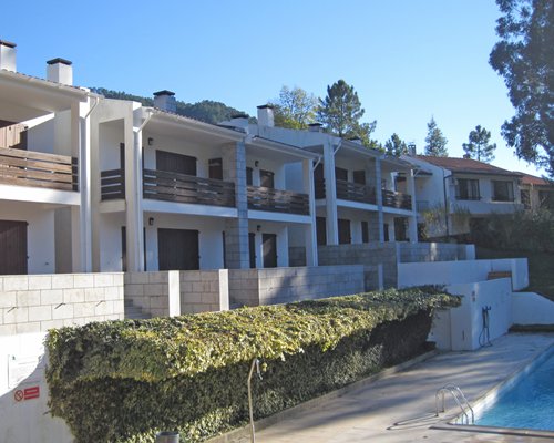 Exterior view of multiple unit balconies with outdoor swimming pool.