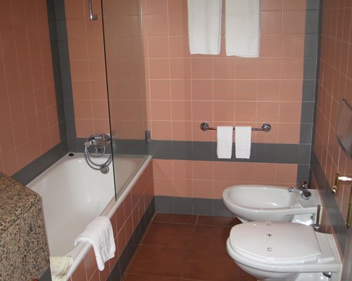 A bathroom with shower sink and bathtub.