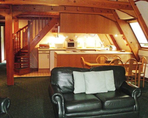 An open plan furnished living room with dining and kitchen area.