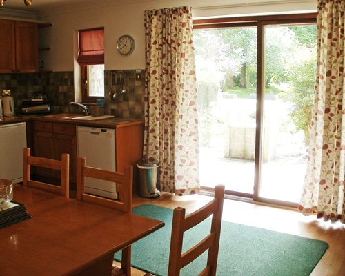 An open plan kitchen with a dining area and outside view.