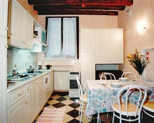 A well equipped kitchen with a dining table.