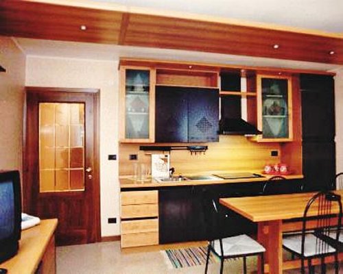 An open plan kitchen and dining area with a television.