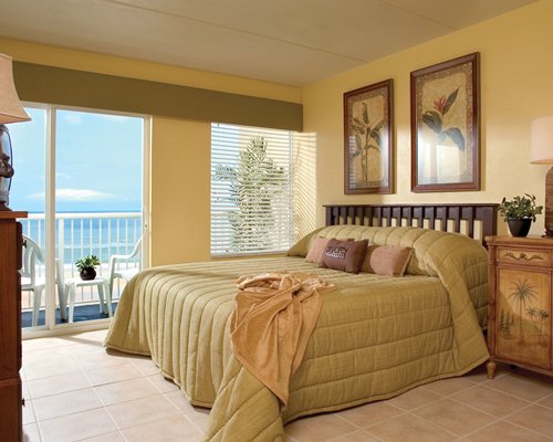 A well furnished bedroom with balcony.