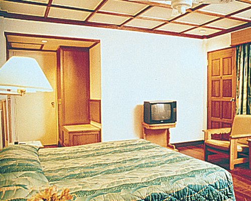 A well furnished bedroom with a television.