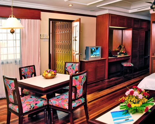 A well furnished dining room with a television.