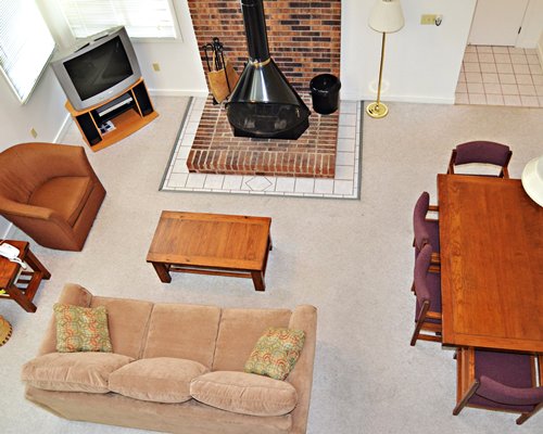 A well furnished living room with a television dining area and fireplace.