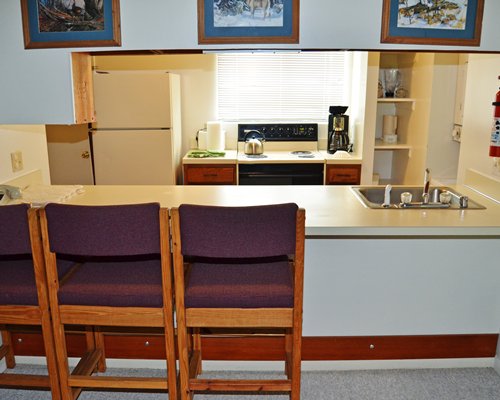 A well equipped kitchen and breakfast bar.