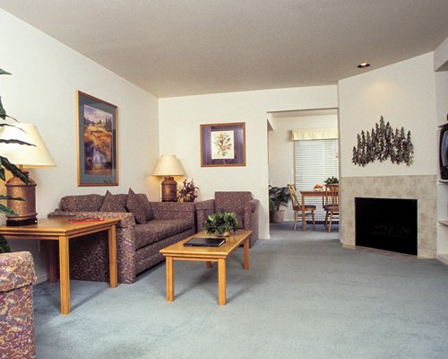 A well furnished living room with a television and dining area.