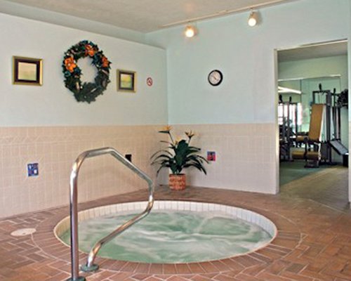 An indoor hot tub alongside the fitness center.