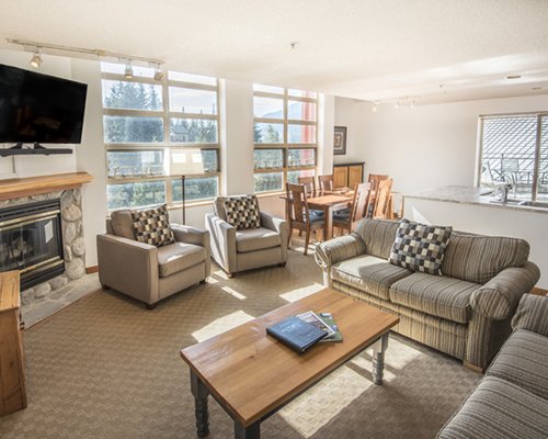 A well furnished living room with a fireplace and a television.