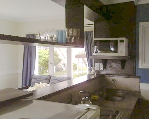 A well equipped kitchen with an outside view.