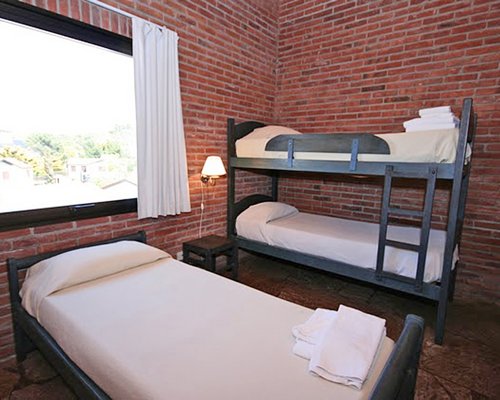 A well furnished bedroom with bunk bed and an outside view.