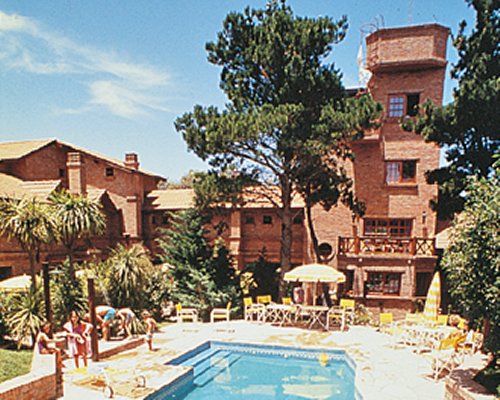 An outdoor swimming pool with chaise lounge chairs.