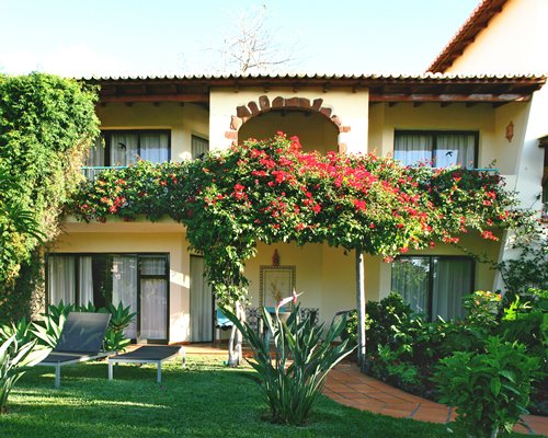 An exterior view with flowers and landscaping.