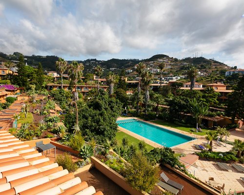 An exterior with outdoor pool and chaise lounge chairs.