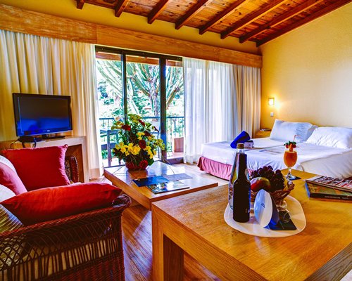 An interior view of studio living area with balcony view.