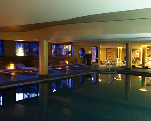 An indoor swimming pool at night.