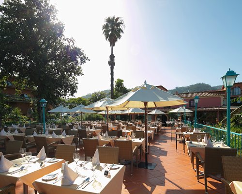 An outdoor restaurant with multiple dining tables.