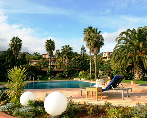 An outdoor swimming pool with landscaped exterior view.