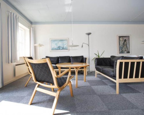 A well furnished living room with a dining area and outdoor view.