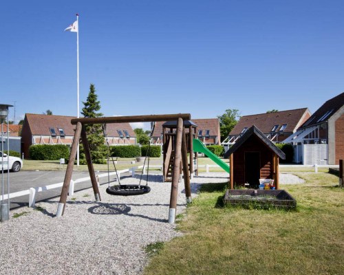 An outdoor playscape area alongside multiple resort units.