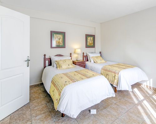 A well furnished bedroom with two twin beds.