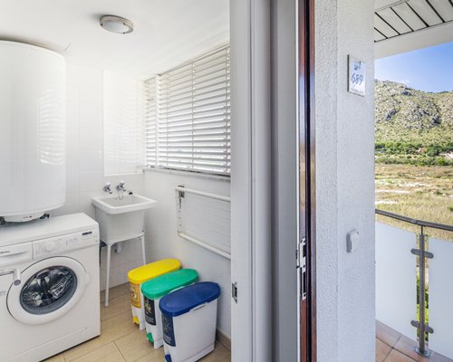 An indoor laundry room with an outside view.