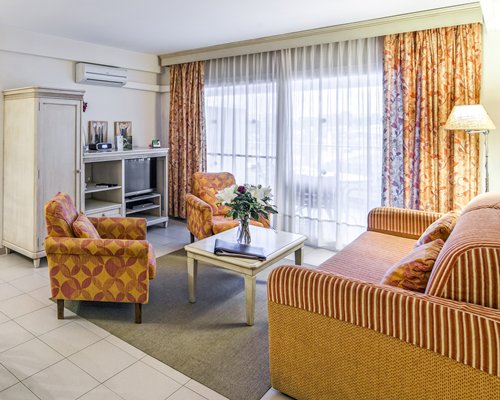 A well furnished living room with a television and outdoor view.