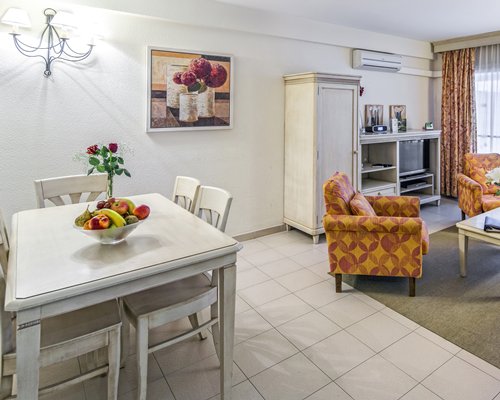 A well furnished living room with dining area and outside view.