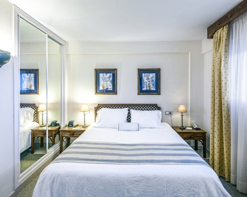 A well furnished bedroom with double bed.