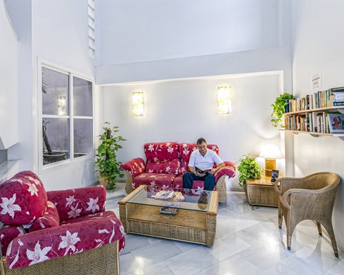 A well furnished living room with a book shelf.