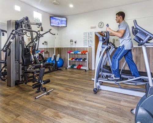 An indoor fitness center with a television.
