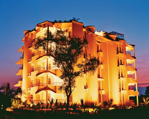 An exterior view of Toshali Sands resort at dusk.