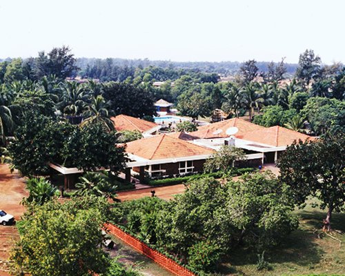 An aerial view of the Toshali Sands resort surrounded by a wooded area.