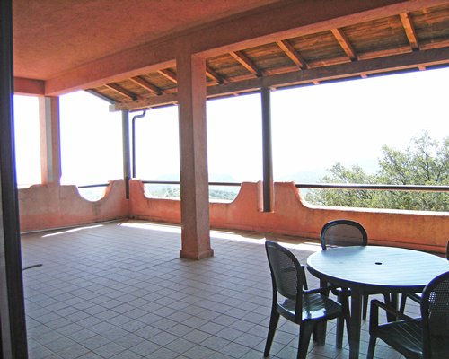 Balcony with patio furniture and an outside view.