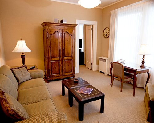 A well furnished living room with a sofa and cupboard.