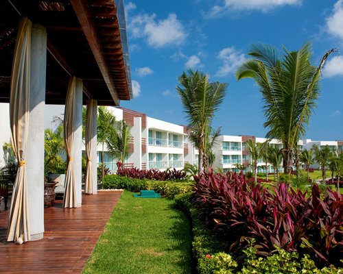 View of outdoor restaurant with multiple unit balconies.
