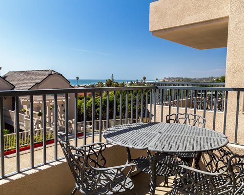 A dining table in a balcony with an outside view.