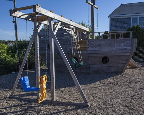 An outdoor children's play area with a swing.