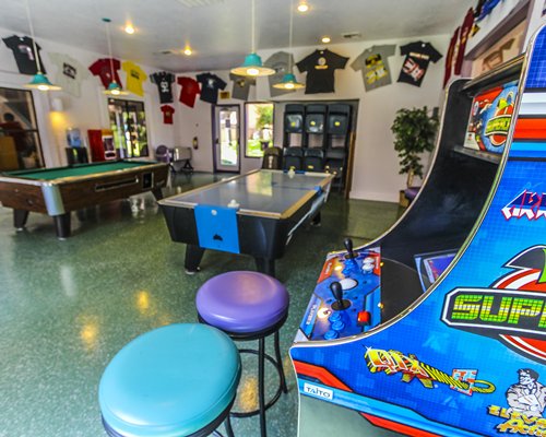 Indoor recreation area with arcade games pool table and air hockey.
