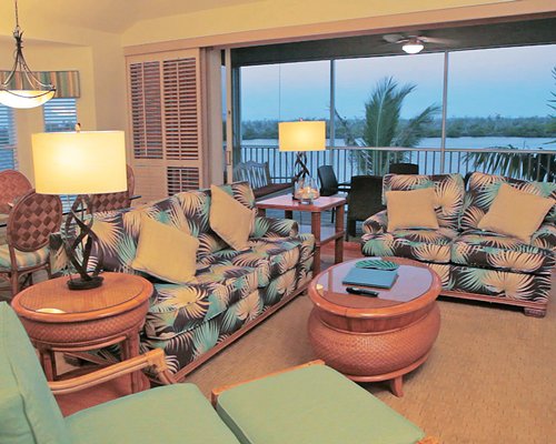 A well furnished living room with a dining area and ocean view.