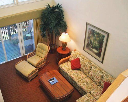 A well furnished living room with a pull out sofa and patio.
