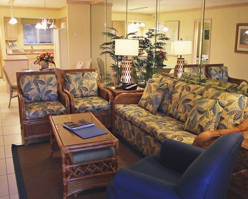 A well furnished living room with open plan kitchen and dining area.