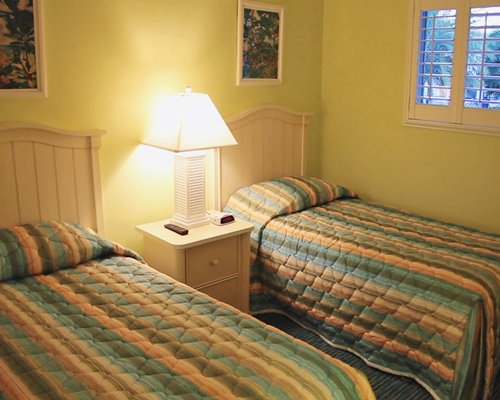 A furnished bedroom with two beds.