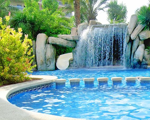 An outdoor swimming pool with fountain.