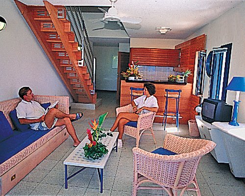 A couple in the living room alongside a breakfast bar.