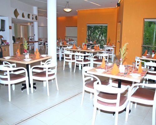Indoor restaurant at Ras Resorts Silvassa with outside view.