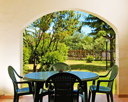Exterior view of patio furniture alongside landscaping.