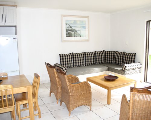 An open living room with double pullout sofa and a dining area.