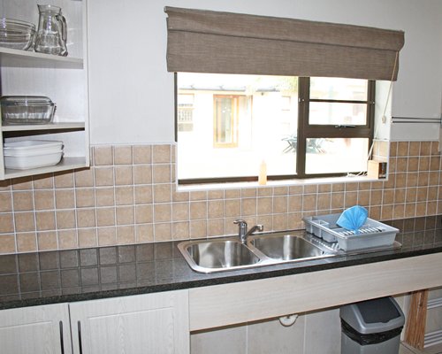 A well equipped kitchen with an outside view.